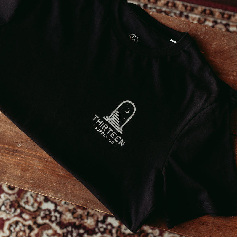 ANYWHERE'S BETTER THAN YOUR OWN MIND - BLACK UNISEX T-SHIRT