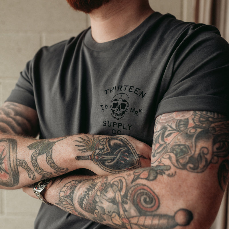 Traditional tattoo chained skull in flames on a unisex grey t-shirt
