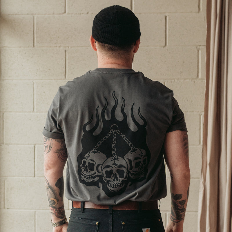 Traditional tattoo chained skull in flames on a unisex grey t-shirt