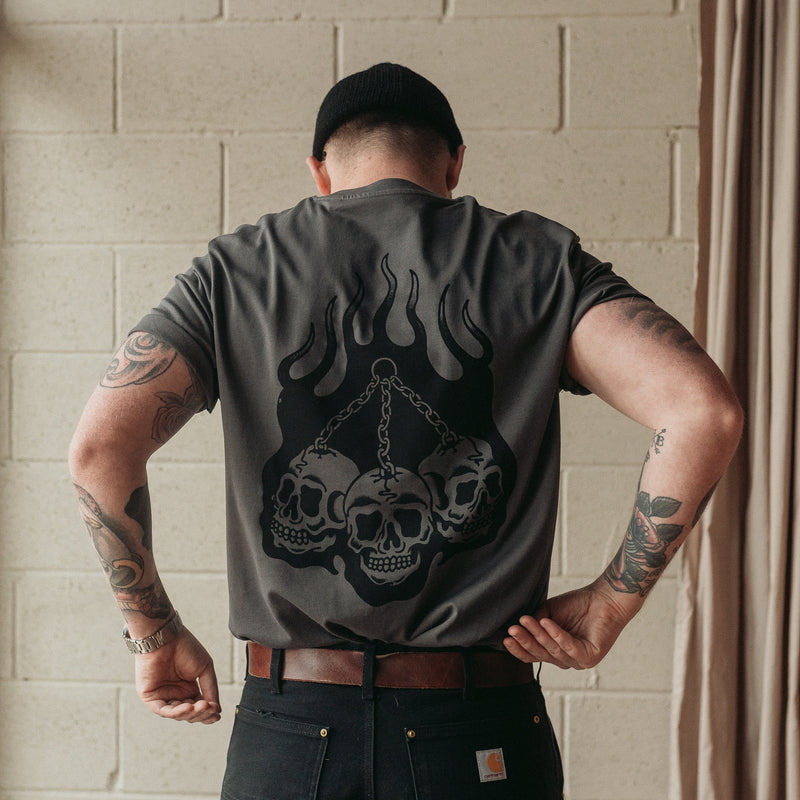 Traditional tattoo chained skull in flames on a unisex grey t-shirt