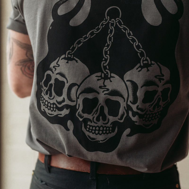 Traditional tattoo chained skull in flames on a unisex grey t-shirt