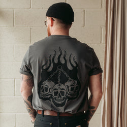 Traditional tattoo chained skull in flames on a unisex grey t-shirt