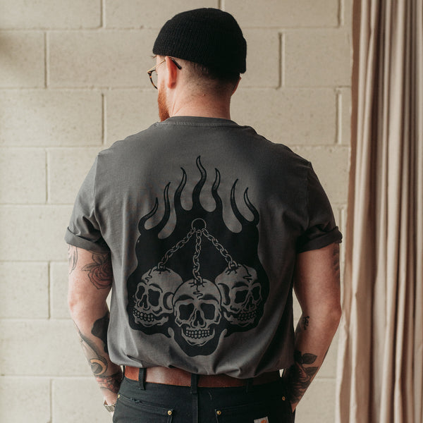 Traditional tattoo chained skull in flames on a unisex grey t-shirt